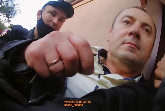 Іосіфавіч прарываецца ў дзверы дома. Скрыншот з відэа, знятага на бодзі-камеру Іосіфавіч прарываецца ў дзверы дома. Скрыншот з відэа, знятага на бодзі-камеру