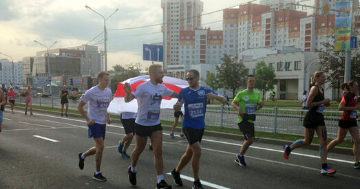 На фінішы мінскага паўмарафона бягуна з бел-чырвона-белым сцягам зацягнулі ў аўтазак